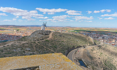 Hilltop windmills, silhouette against the Spanish sky. Toledo's history, culture, and scenic beauty...