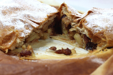 Typical artisanal cake strudel with apples and raisins and cinnamon-