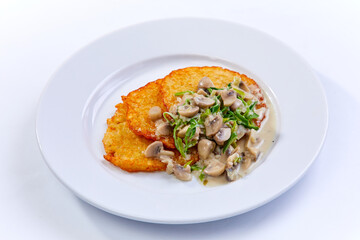 potato pancakes with sauce and mushrooms