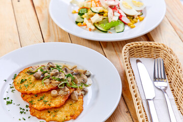 potato pancakes with sauce and mushrooms