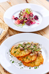 potato pancakes with sauce and mushrooms