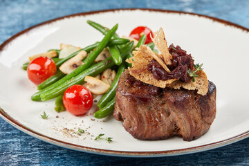 grilled steak with vegetables and sauce