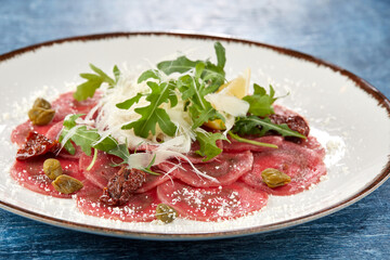 fresh carpaccio with parmesan and arugula