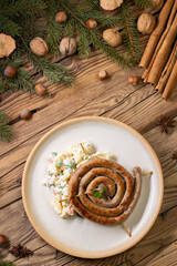Obraz na płótnie Canvas Christmas wine sausage served with potato salad