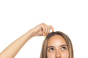 half portrait of a young woman scratching her head on a white background