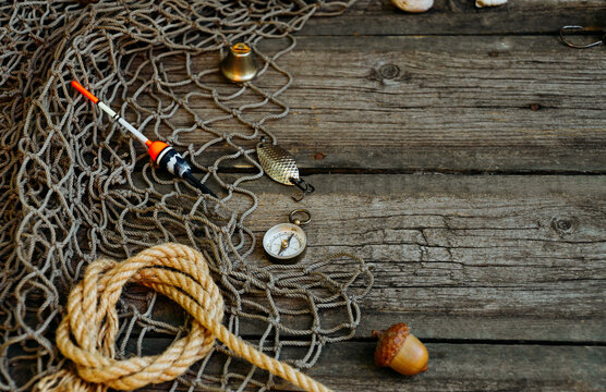 Float lay on fishing nets on wooden background