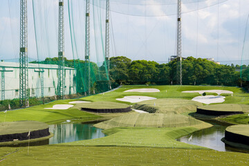 Golf driving range made of large green wire mesh
