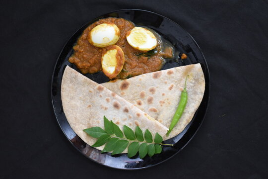 tasty chapathi chapati with egg masala gravy black plate background