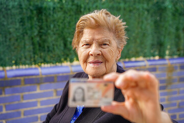 retired woman showing National identity document. Old age identification and personal rights....