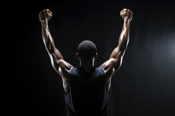 Rear view of a basketball player with his arms in the air