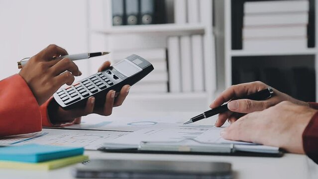 Business accounting concept, Business Man using calculator with computer laptop,pen, budget and loan paper in office.