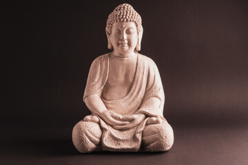 White sitting Buddha statue. Smooth background. Lotos position. 