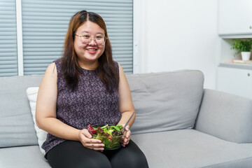 Asian Overweight woman dieting Weight loss eating fresh fresh homemade salad healthy eating concept Obese Woman with weight diet lifestyle.