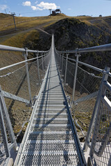 An himalayan pedestrian bridge allows hikers and tourists to access a point of view on surrounding summits