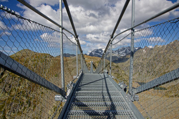 An himalayan pedestrian bridge allows hikers and tourists to access a point of view on surrounding...