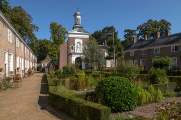 Beguinage in Breda with 29 houses around a herb garden with the Saint Catherine Church in the background.