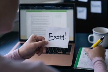 A student woman studying for an exam, sitting at her desk and computer writing notes.