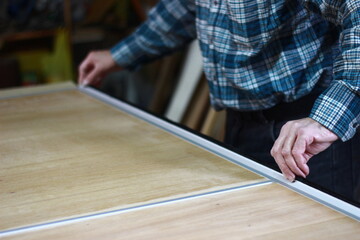 carpenter putting protection on a table frame