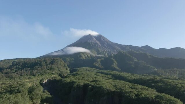 Stunning aerial view of Mount Merapi, a beautiful and peaceful active volcano. Beautiful wild natural views around the mountain in the form of dense forests, valleys and hills