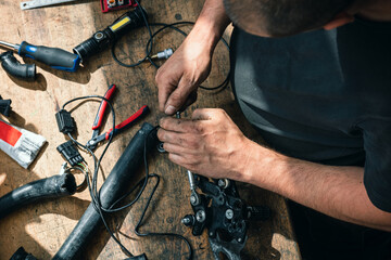 professional person or mechanic working in workshop or garage with tools for auto or bike repair