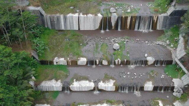 Aerial footage of the Watu Purbo sabo dam in Sleman, Indonesia which has a 6-level water dam. Apart from preventing the eruption of Mount Merapi, this dam is also a popular tourist destination