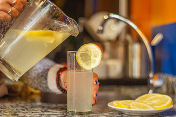 Preparing a fresh lemonade on a glass
