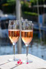 Summer party, drinking of French brut rose champagne sparkling wine in glasses in yacht harbour of Port Grimaud near Saint-Tropez, French Riviera vacation, France