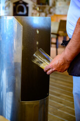 Pouring from high height of natural Asturian cider made from fermented apples in cafe, Oviedo, Spain