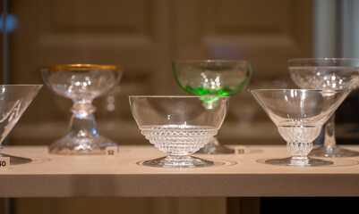 Old and vintage collection of empty wine or champagne bubbles wine glasses on display