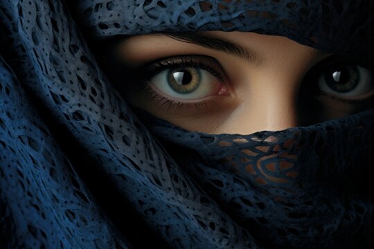 A close-up image of a woman's eyes with a veil elegantly draped over her head. This stunning photograph captures the mystery and allure of a veiled gaze. Perfect for fashion editorials, beauty blogs, 