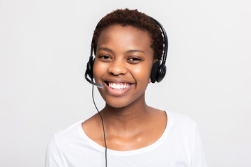Portrait of cheerful delighted young woman call centre operator in headphones on hotline at workplace working - obrazy, fototapety, plakaty
