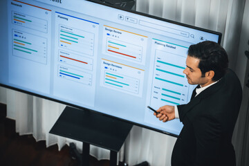 Project manager planning schedules for business task at meeting room, Gantt chart software show on...