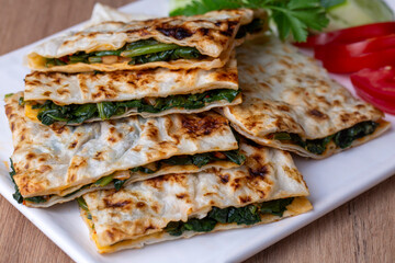 Traditional Turkish food, Turkish pancake gozleme with cheese and herb. The appetizer is Turkish pastry. There are varieties such as cheese, spinach, potato. - obrazy, fototapety, plakaty