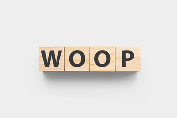 WOOP (Wish, Outcome, Obstacle, Plan) wooden cubes on grey background