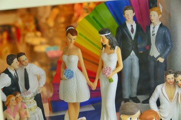 lgbtq wedding cake topper on display at shop window