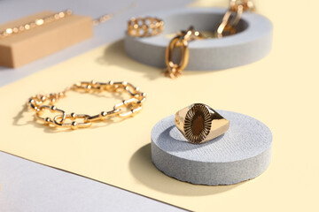 Showcase pedestals with beautiful jewellery on color background