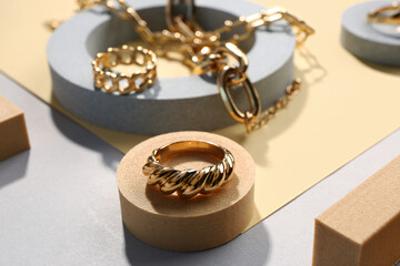 Showcase pedestals with beautiful jewellery on color background