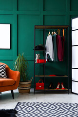 Shelving unit with clothes and accessories in interior of dressing room