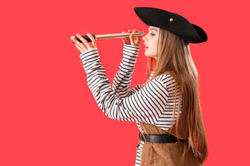 Beautiful female pirate with spyglass on red background - obrazy, fototapety, plakaty