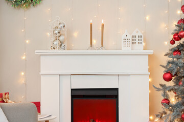 Interior of festive living room with fireplace and glowing lights