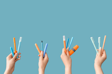 Female hands with school supplies on blue background