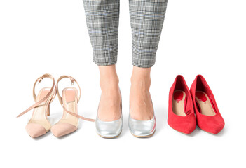 Woman with different shoes isolated on white background