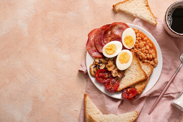 Plate of tasty English breakfast with boiled eggs on beige background