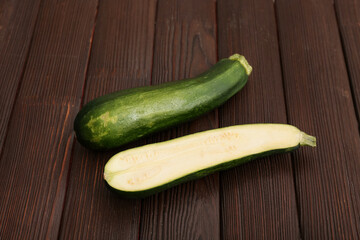 Fresh green zucchini on wooden background