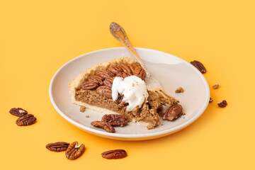 Plate with piece of tasty pecan pie on yellow background