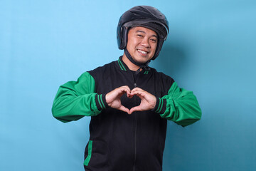 Young Asian online driver man smiling showing heart shape hands