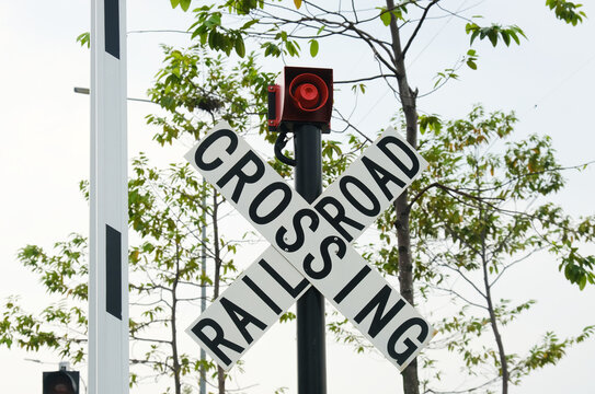 Selective focus picture of railroad crossing sign at tram railway in the morning