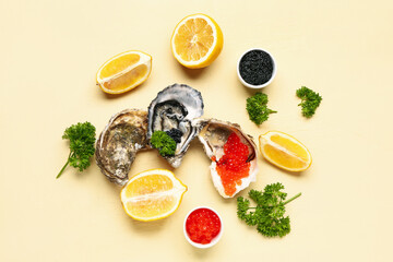 Tasty oysters with lemon, black and red caviar on yellow background