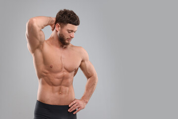 Fototapeta na wymiar Handsome muscular man on light grey background, space for text. Sexy body