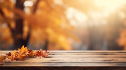 Naklejka na ściany i meble Wooden table with autumn leaves on bokeh background. Autumn concept
